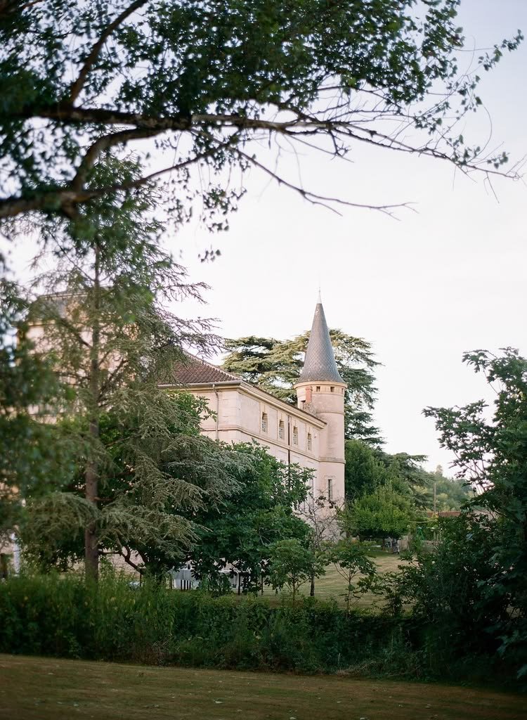 The château glimpsed through the trees