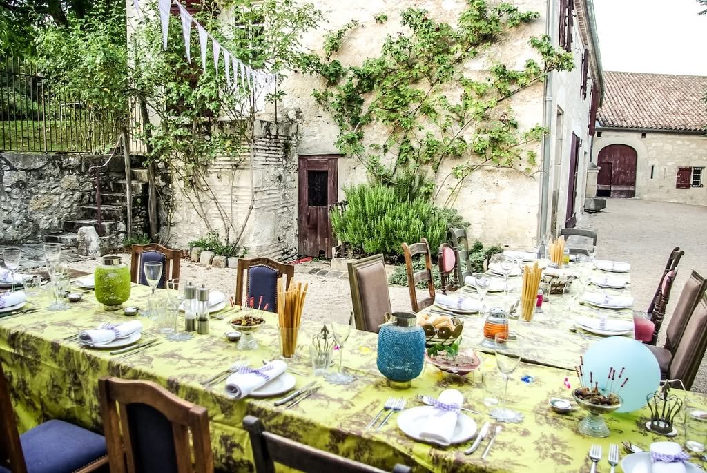 A long table set for dinner in the courtyard