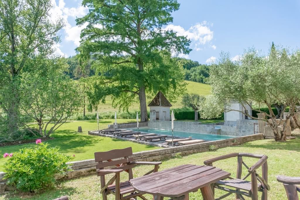 The garden, with outdoor tables and the pool beyond