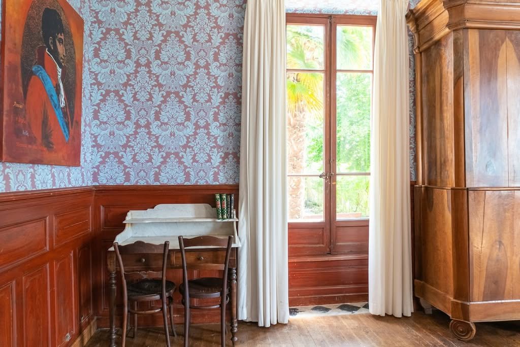 A writing desk by the French windows