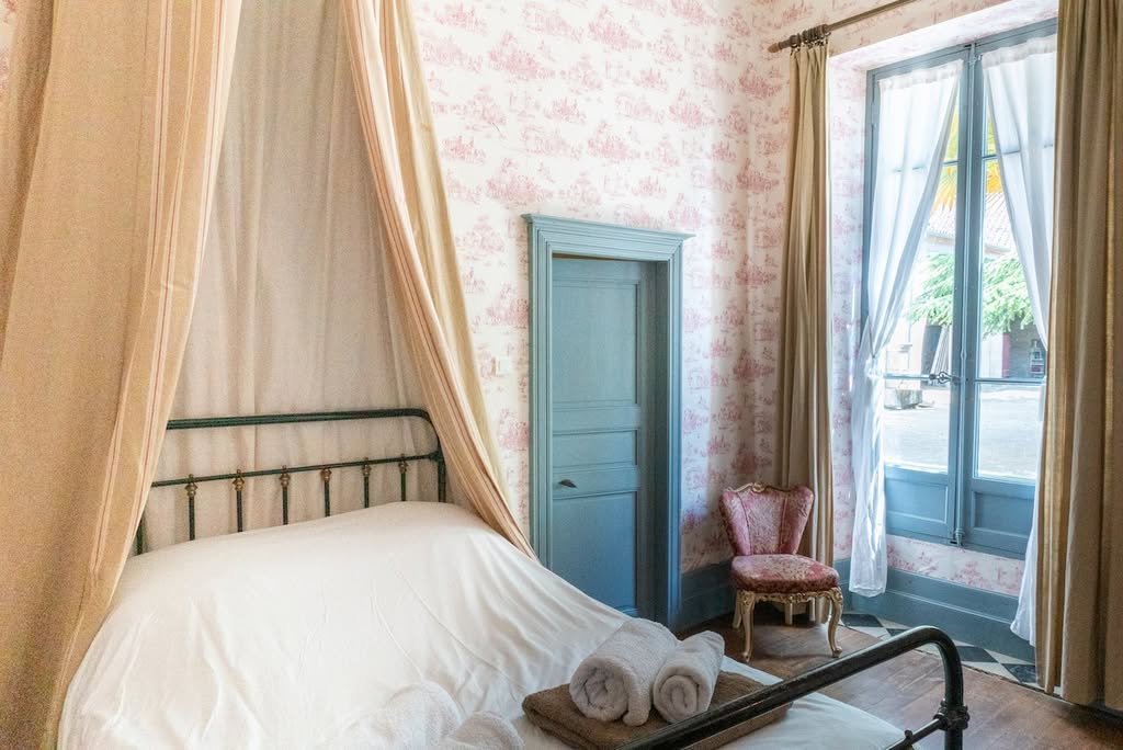 A canopy bedroom in soft pink